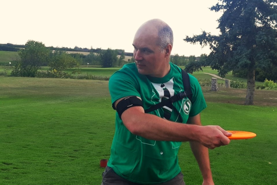 Curtis tests out a ThroForm training harness, designed to limit movement and improve swing mechanics during the championships.
