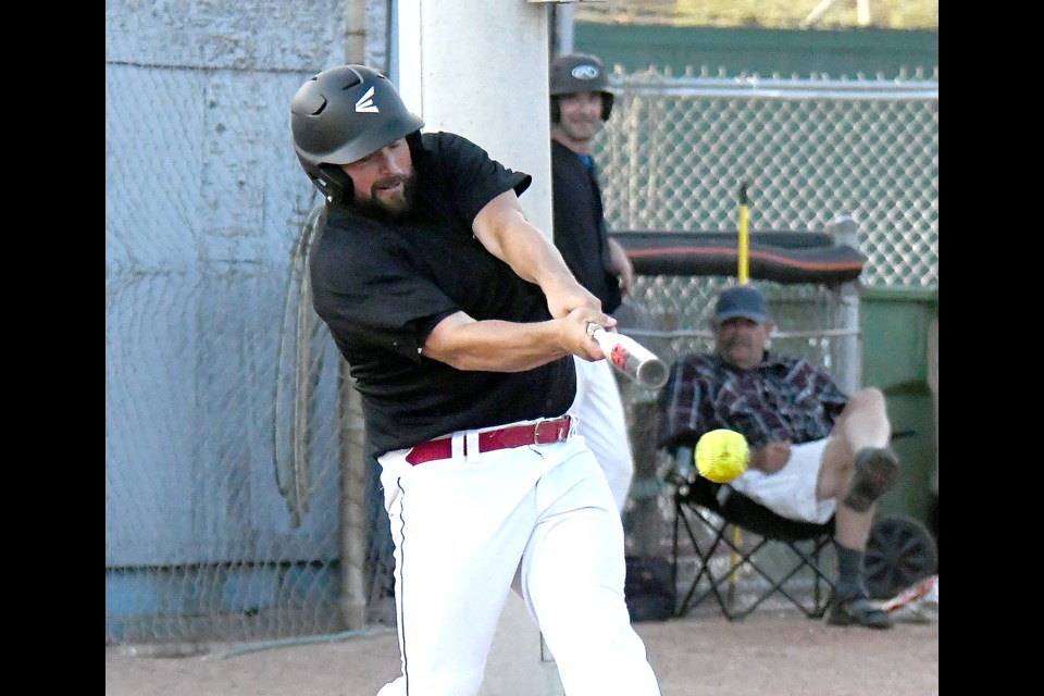 Jay Livingston fouls off a pitch in the fourth inning… and one offering later, would hit a grand slam over the centre field fence.