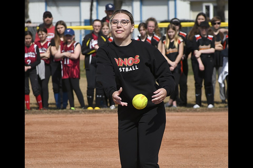University of Calgary pitcher Madison Thul tosses a strike for the ceremonial opening pitch of the season.