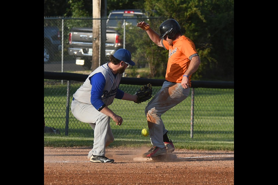 Giants baserunner Joe MacDonald watches as the ball skips away from the third baseman, leading to him scoring his second run of the game.