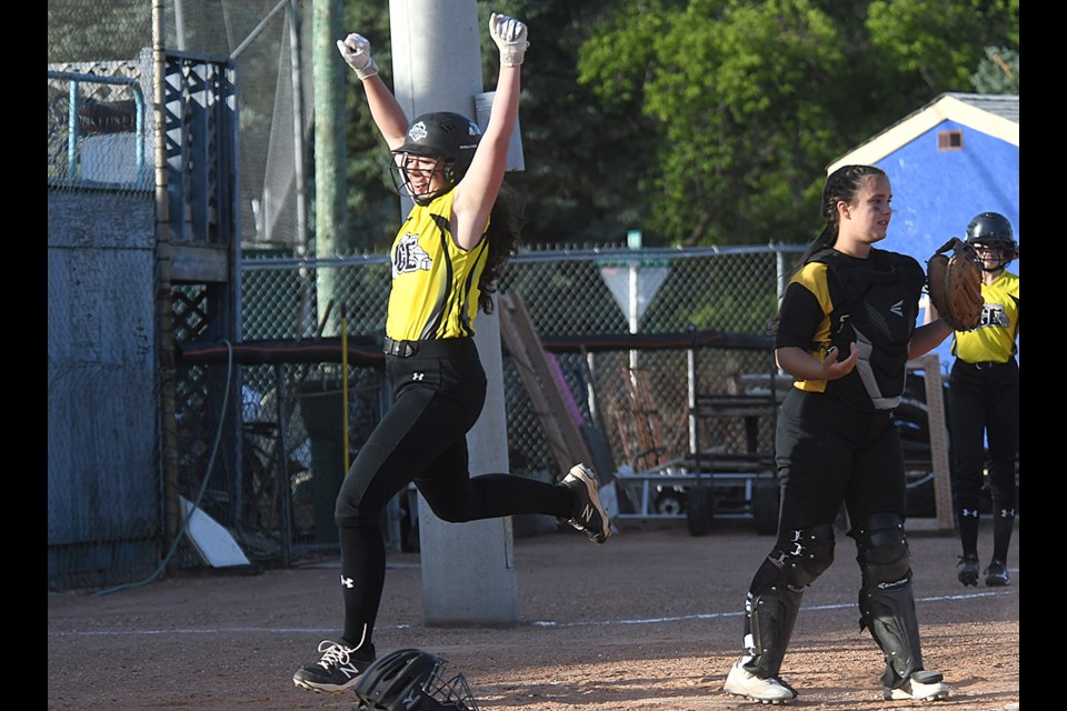 Peyton Mengel celebrates while crossing the plate after hitting an inside-the-park home run in the third inning of game one. 