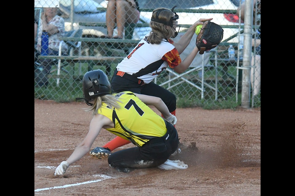 Sidney Miskiman slides home to score her third run of the game.