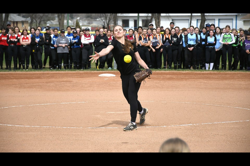 Former Moose Jaw U17 AA pitcher Katie Newberry delivers the ceremonial season-opening pitch to teammate Makena Simmons. The reigning provincial champions were joined by fellow players Jasmine Kohl and Cassia Montgomery in representing the team.