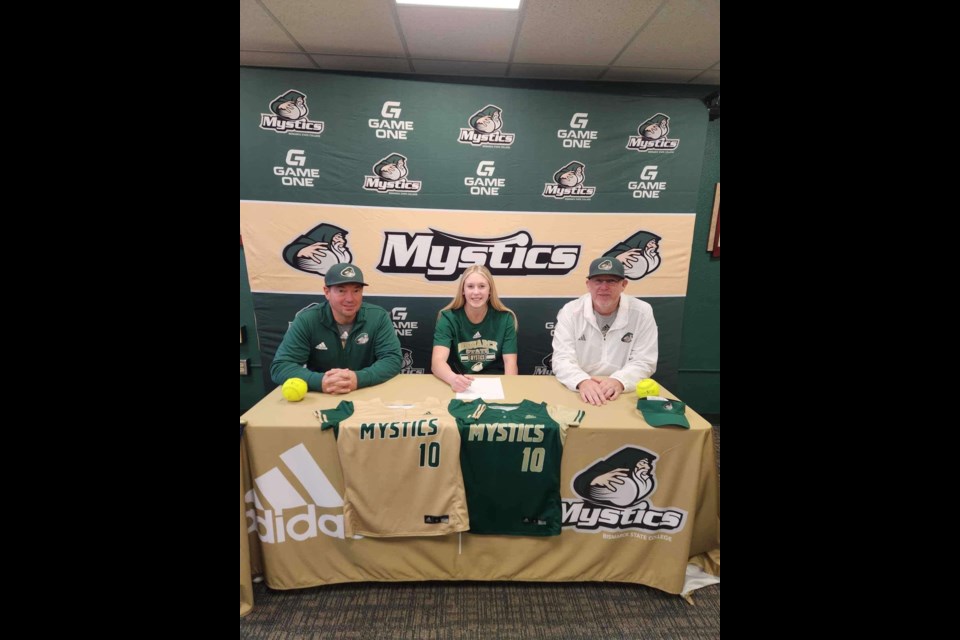 Haily Molde (centre) commits to playing Fastball for Bismarck State College's Mystics