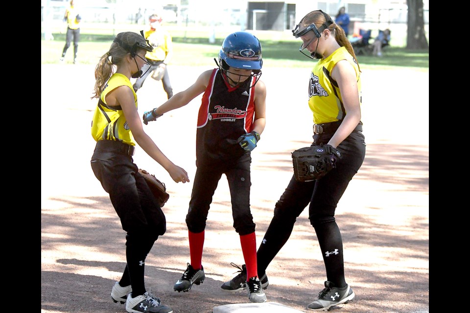 Georgia Fowler (right) gets back to the base just a little too late as the Humboldt Thunder baserunner beats the force and Sophia Johnstone covers the play.