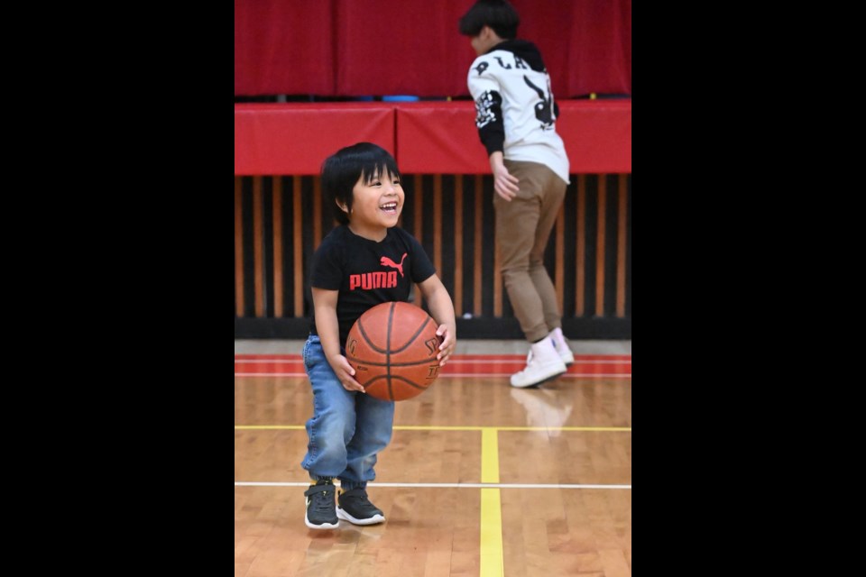 Even toddlers were out during a break in the game action as the gym floor was swarmed with dozens shooting hoops
