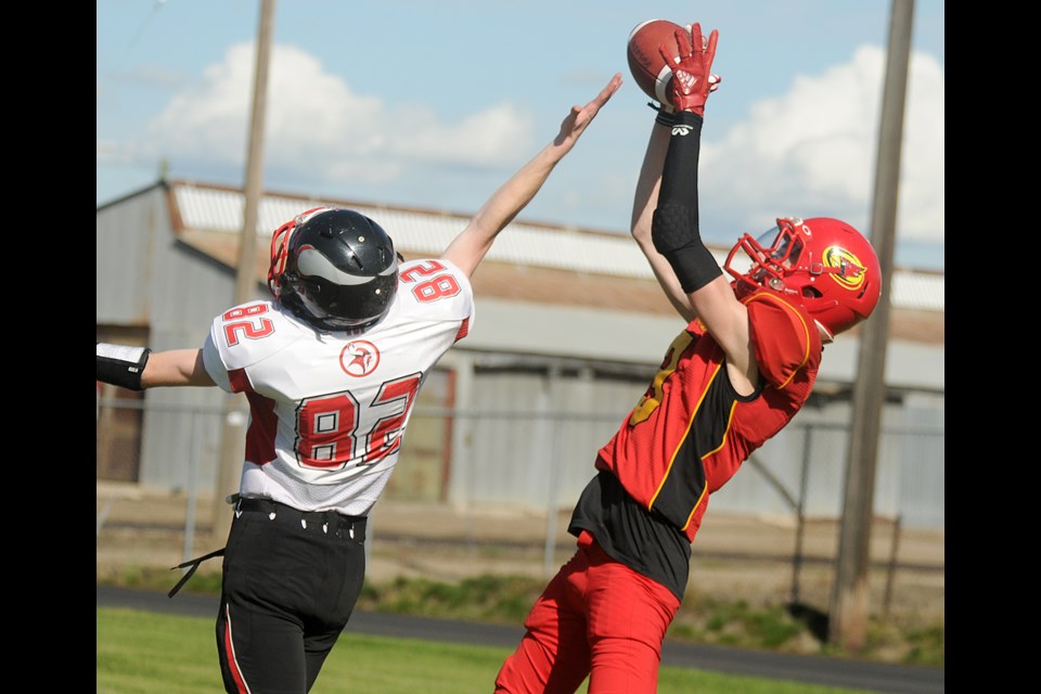 Central’s Dylan Boughen hauls in a catch in the endzone as Vanier’s Julian Allen just misses tipping the pass.