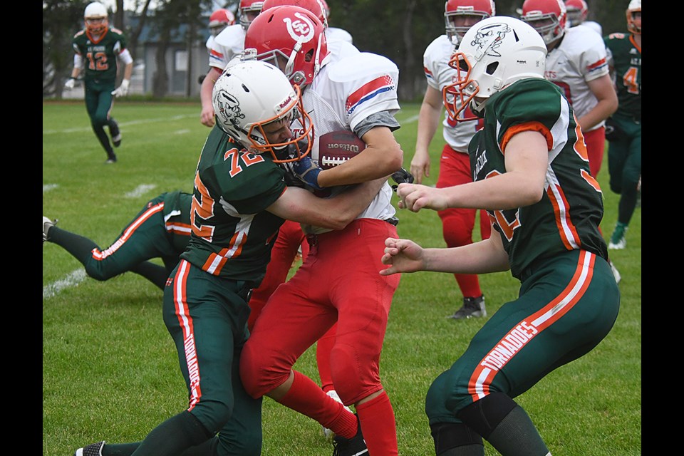 Peacock’s Kalen Lopston wraps up the Swift Current ball carrier.