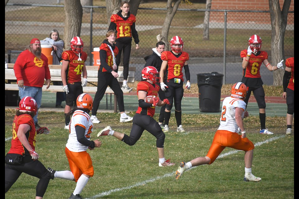 Cyclones defensive lineman Chris Nelson runs the ball back after a crucial interception in the third quarter.