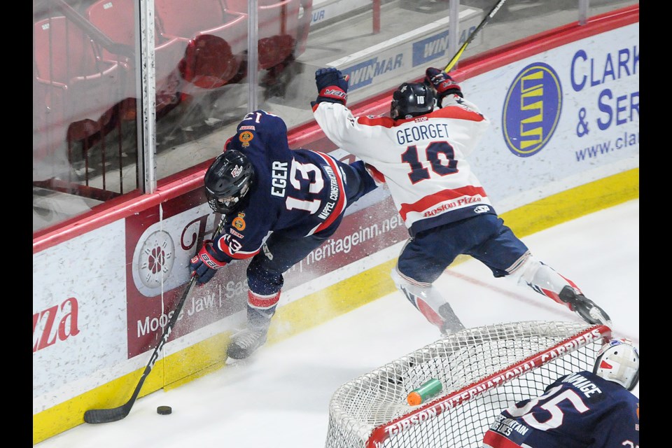 Moose Jaw's Jaxon Georget crashes into Regina's Sebastian Eger behind the Moose Jaw net. Randy Palmer photograph