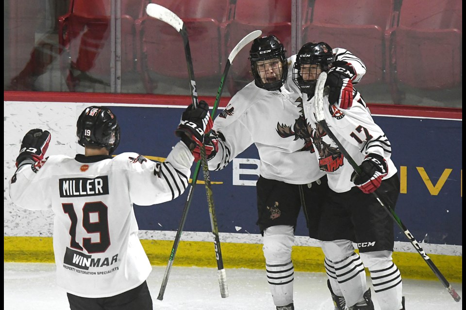 Liam Fitzpatrick (centre) celebrates his second goal of the game with Grady Hoffman (17) and Connor Miller.