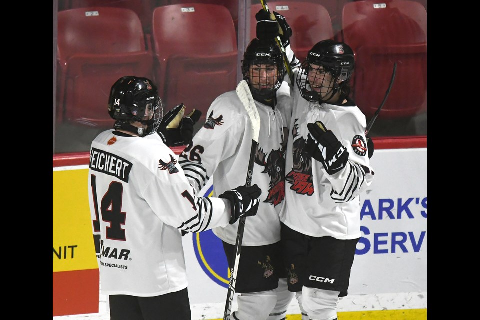 The WINMAR Warriors celebrate after Dylan Duzan scored the game-winning goal late in the third period.