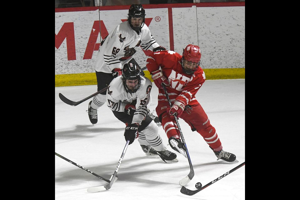 The Warriors’ Austin Woodley aims to get better position on a Hounds defender in the Notre Dame zone.