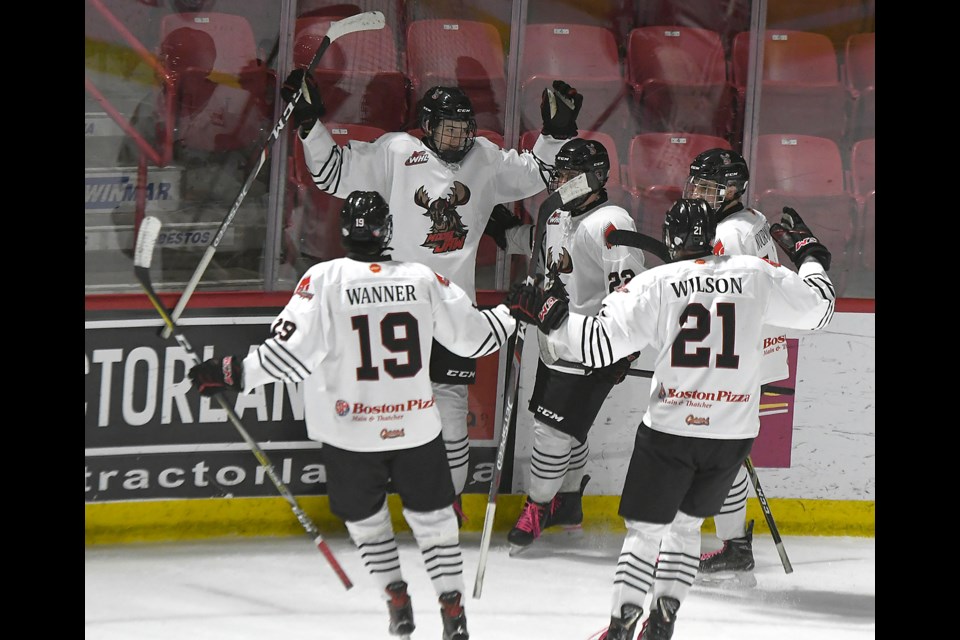 Davis Fry celebrates with his AAA Warriors teammates after scoring his second goal Sunday.