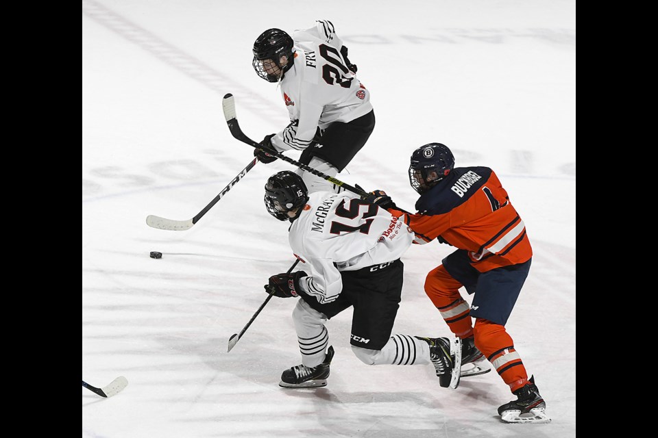 Warriors forwards Davis Fry and Connor McGrath break up the ice during overtime.