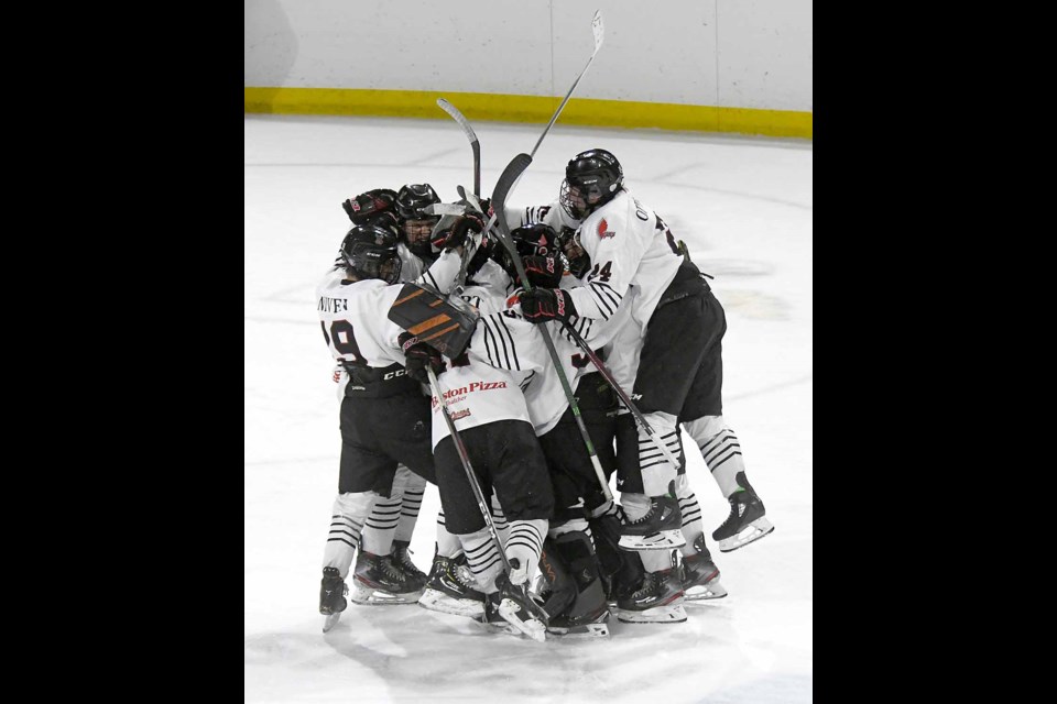The AAA Warriors celebrate after Kirk Mullen scored the overtime winner.