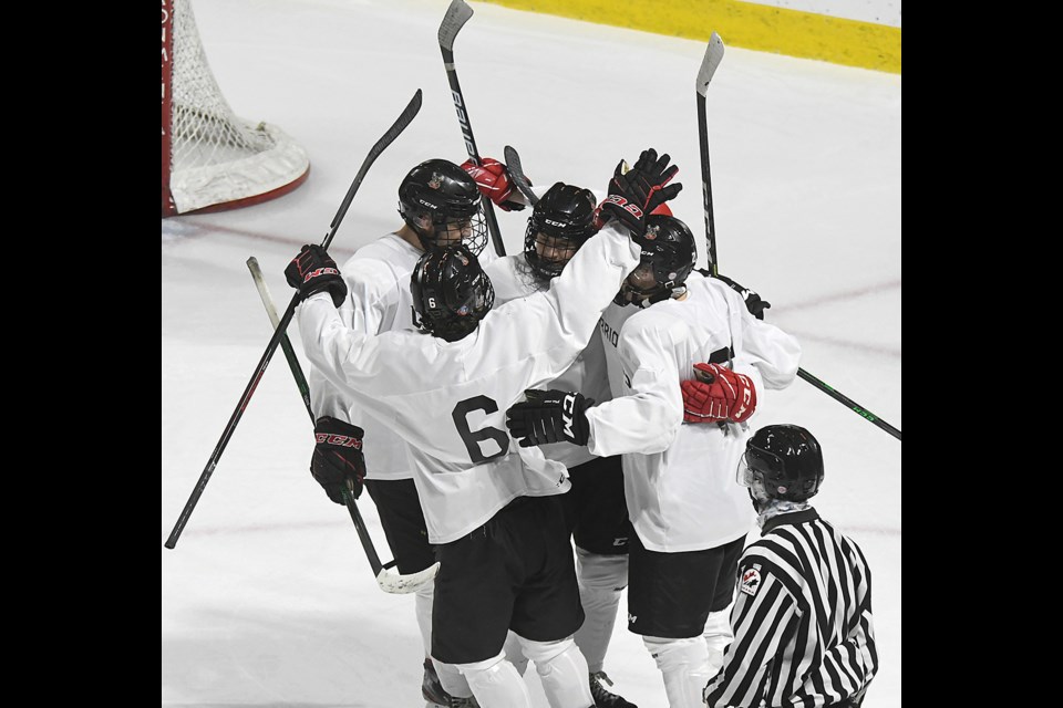 The Warriors celebrate after Jackson Allan’s second-period goal.