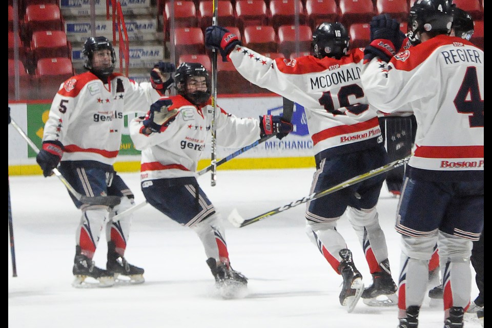 Casey McDonald celebrates with his teammates after scoring the overtime winner. Randy Palmer photograph