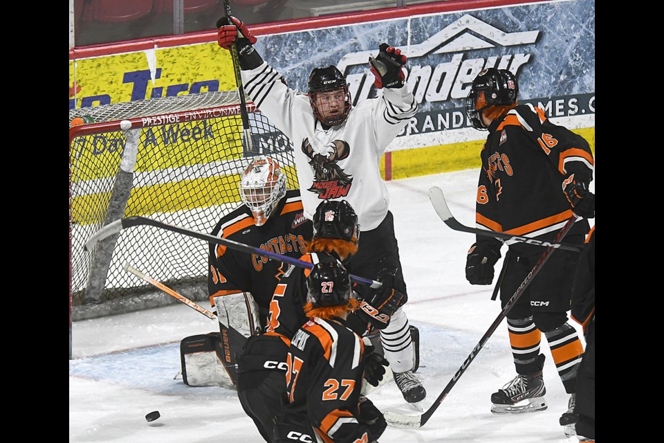 Connor Miller celebrates after Ryder Knutson scored the Warriors’ sixth goal of the game.