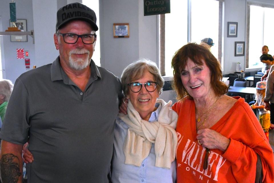 Fran Banting, centre, celebrates her 90th birthday surrounded by family during the Dave Banting Memorial Golf Classic at Lynbrook Golf Course.