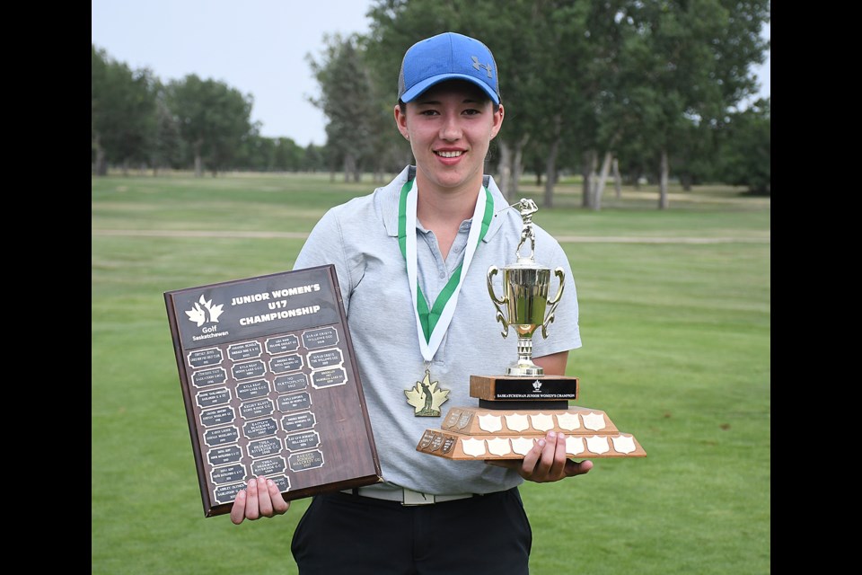 Brooklin Fry with the Golf Saskatchewan U17 and U19 provincial championship trophies