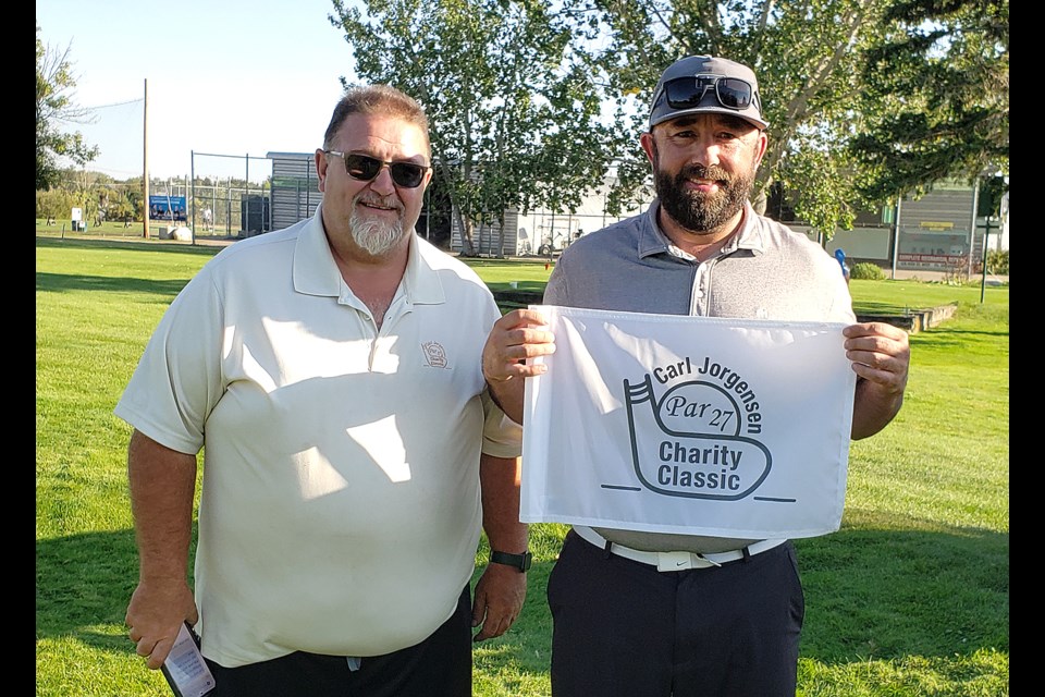 Lynbrook Golf Cllub’s Owen Morhart (left) presents the Carl Jorgensen championship flag to 2024 winner Shawn Muchowski.