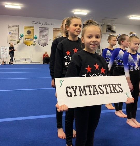 Viktoriia Ilnitska (front, holding sign), Olivia Sewell (middle), and Sawyer de Graauw (back).
