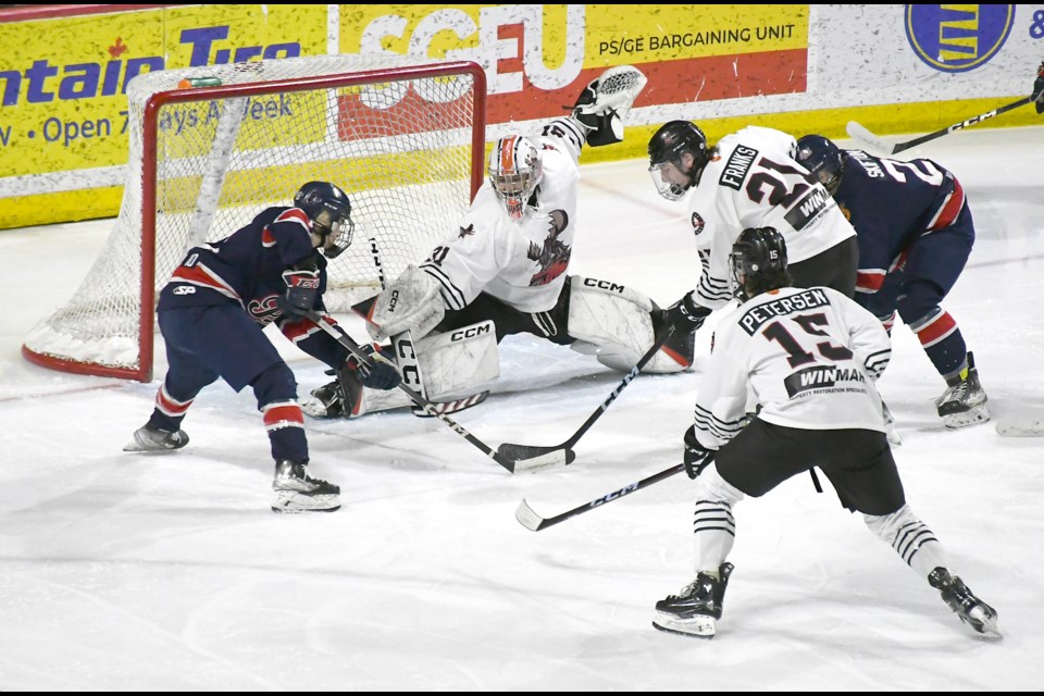 The Warriors’ Kanyan Unger looks to foil a clearing attempt by the Pat Canadians’ Cruz Klapak.