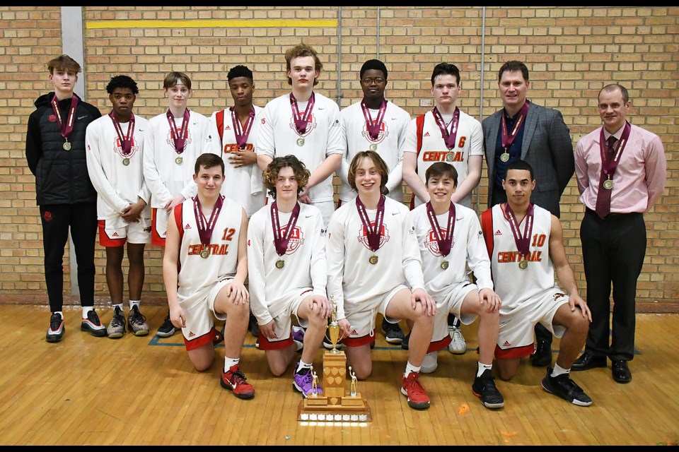 The Central Cyclones gather for the customary team photo after winning their fifth straight high school boys basketball title.