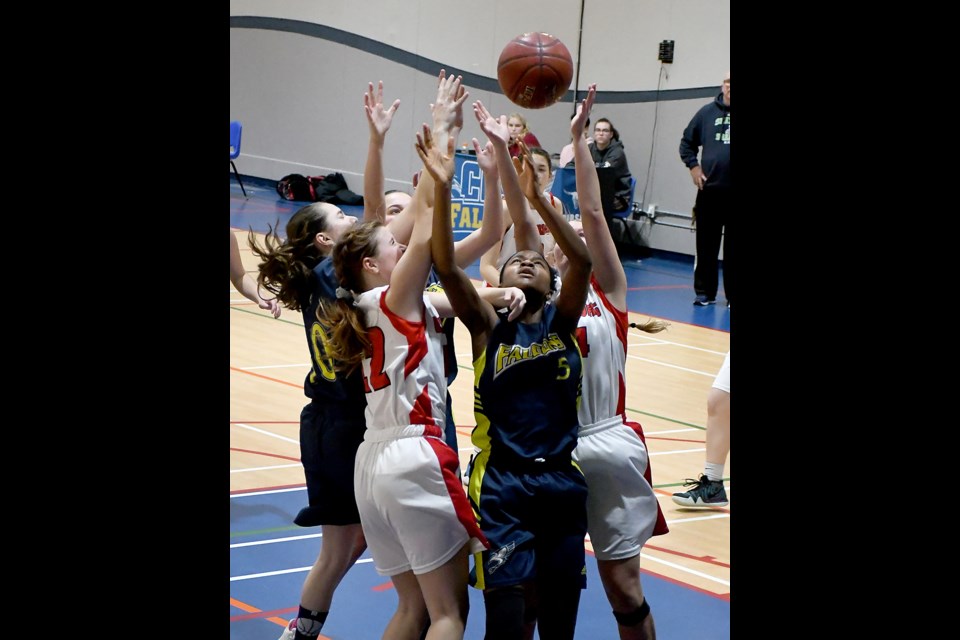 Players from Cornerstone and Unity battle for a rebound under the basket.