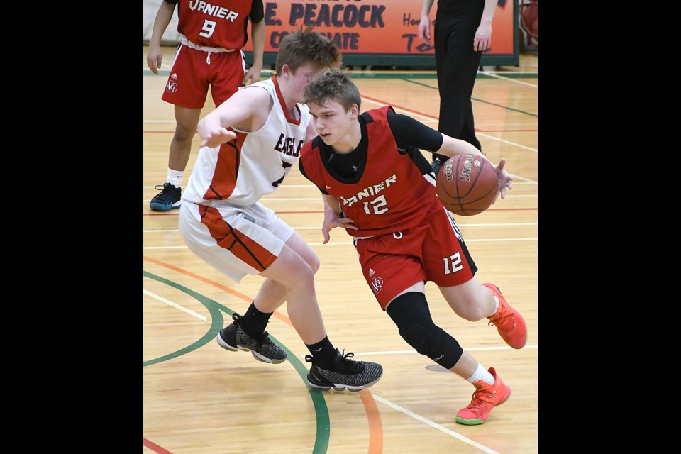 Vanier guard Aidan Longworth drives past an Eagles defender.