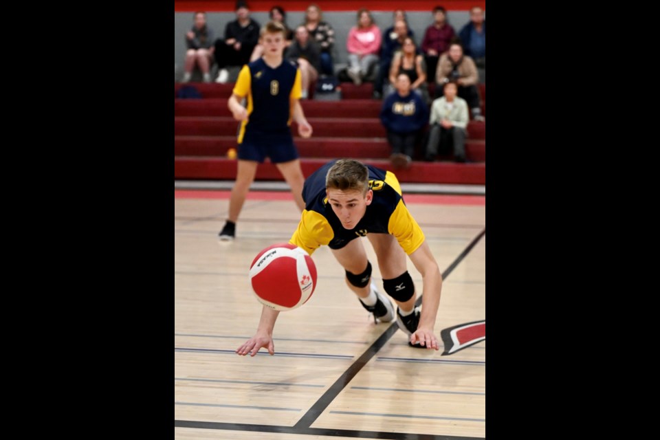 Cornerstone Christian School Falcons D Biette, dives in an unsuccessful attempt to dig a ball headed just inbounds