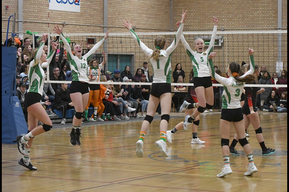 The Peacock Toilers celebrate winning the Moose Jaw high school girls volleyball championship.