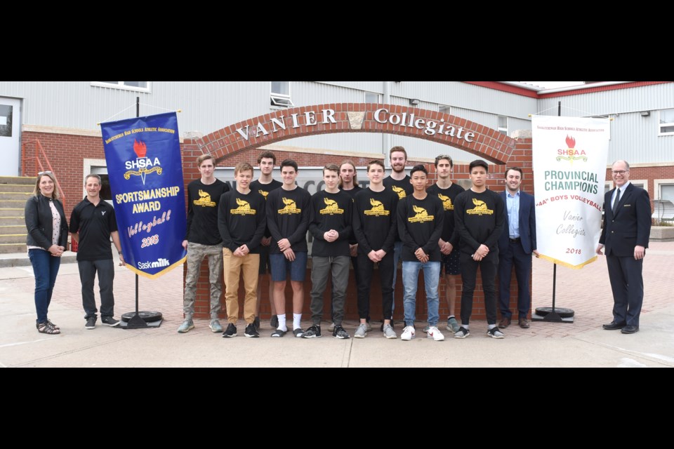 Members of the Vanier Vikings 4A boys volleyball provincial champions with their championship and SaskMilk Sportsmanship banners.