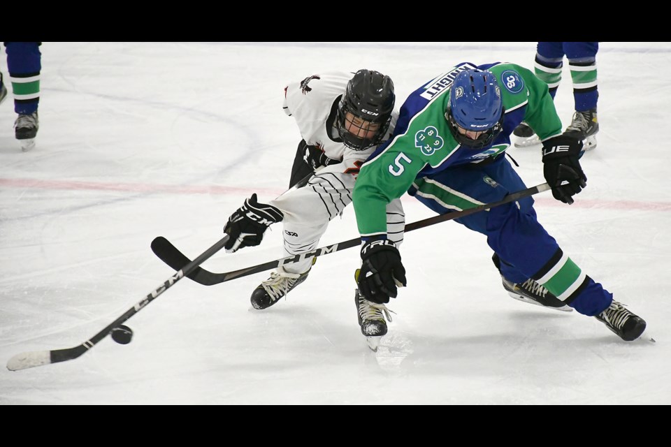 Marc Belanger battles for the puck with Swift Current’s Cutter Knight.