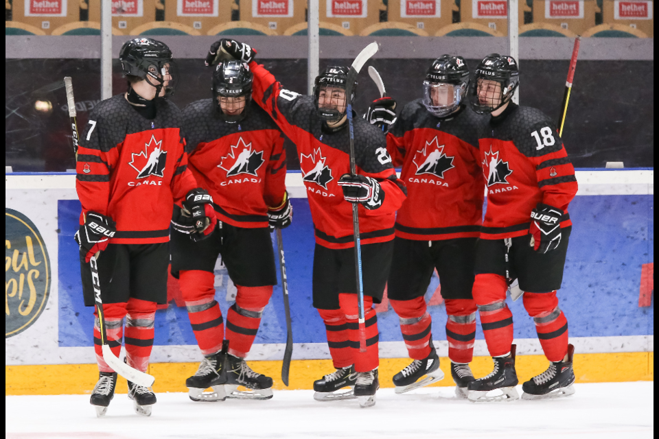 Brayden Tracey (far left) celebrates a goal with his Team Canada teammates. Photo by Chris Tanouye/HHOF-IIHF Images.