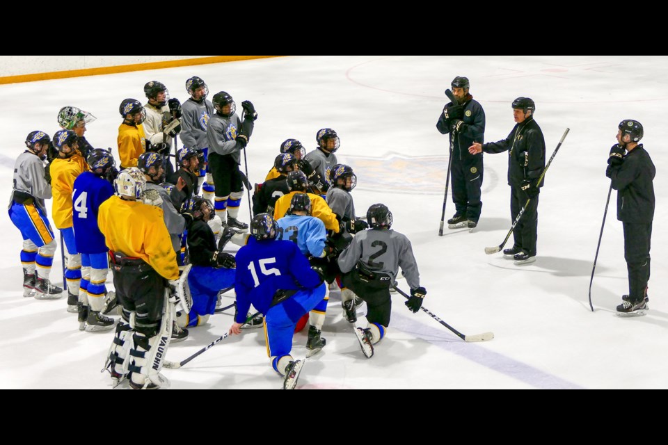 The Prairie Hockey Academy Cougars listen in as Dave King offers a few words of hockey wisdom. PHA photo