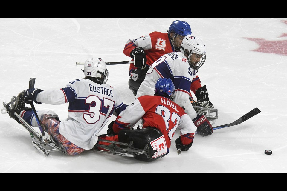 Players from the United States and Czechia battle for the puck during third period action.