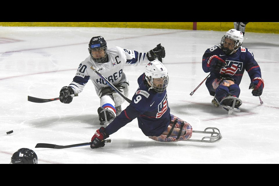 Korea captain Jang Dong Shin fires a pass behind U.S. defender Travis Dodson as Malik Jones follows the play.