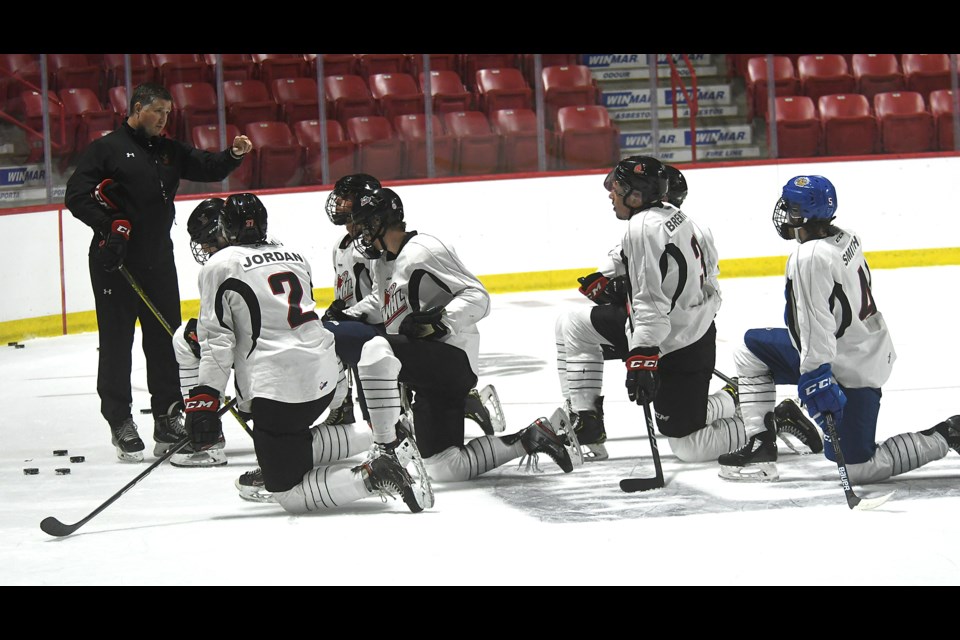 Warriors assistant coach Gordon Burnett walks the defence through a drill during the Warriors first training camp practice.