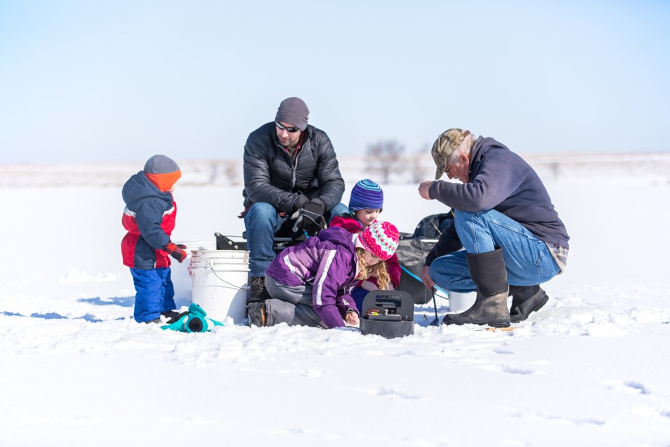 A family goes ice fishing together