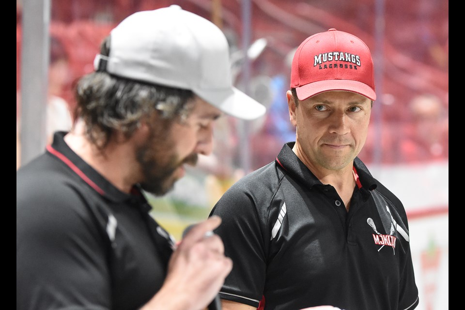 Steve Michaluk listens in as one of his former players, Derek Burns, offers a few words to start the pre-game ceremony.