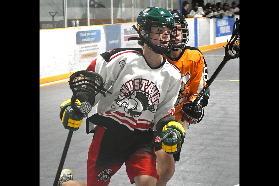 The Mustangs’ Hayden Nidesh makes his way to the front of the net before scoring a goal.