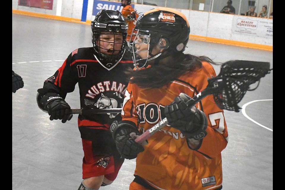 Mustangs attacker Keegan Flanagan looks to lower the boom on Standing Buffalo’s Sophia Yuzicappi.