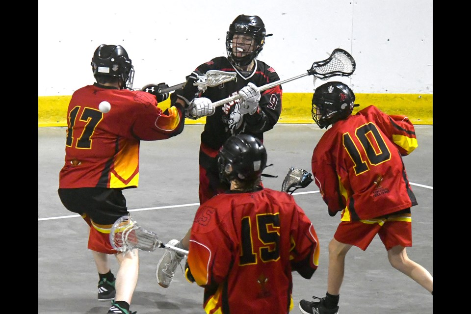 Moose Jaw’s Chase Folk sends a pass cross floor against a trio of Thrashers defenders.