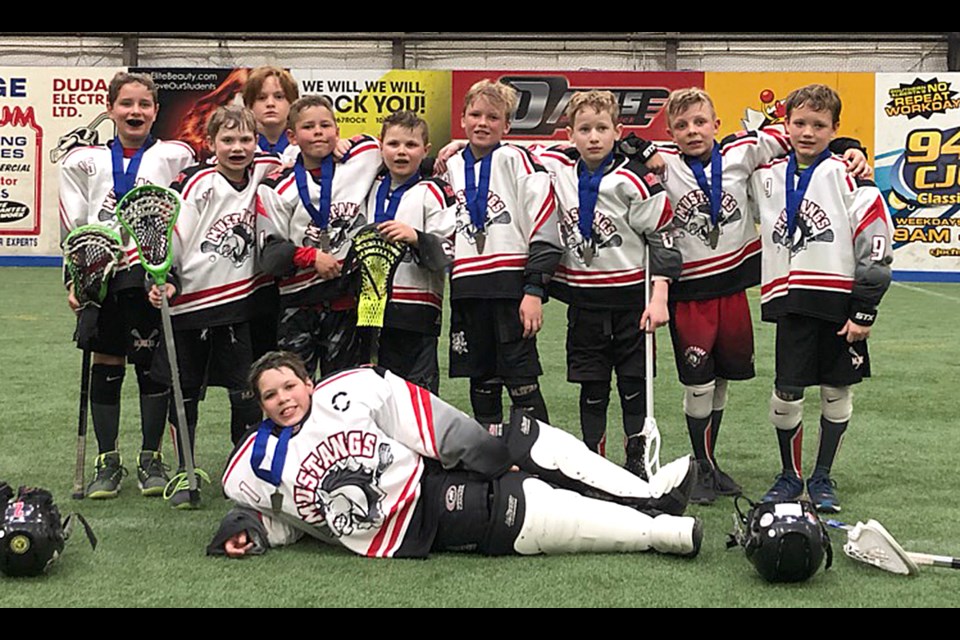 The Moose Jaw Novice 1 Mustangs gather for a team photo after their silver medal win in the Lethbridge Floorbusters tournament.