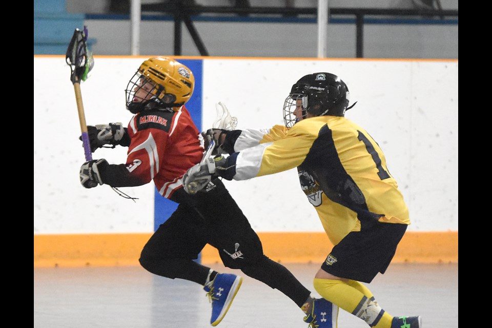 The Mustangs’ Nathan Bandet absorbs a cross-check from a Swift Current Rampage defender but kept right on going to the net.