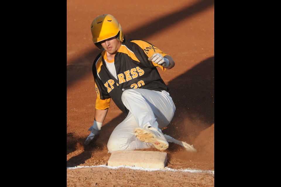 Express batter Alex Orenczuk slides safely into third and would score the game’s first run.