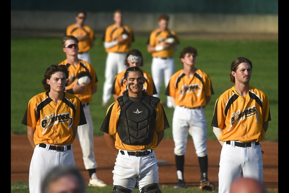 The Miller Express take in the national anthem prior to the contest against the Regina Red Sox.