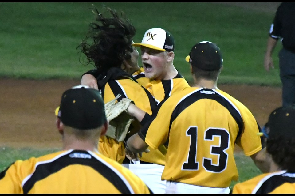 Miller Express closer Reece Helland celebrates with catcher Bryan Reyes after recording the final out against Medicine Hat.